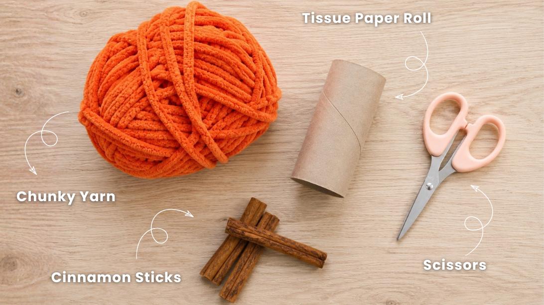 Craft Supplies Needed - tissue paper roll, chunky chenille yarn, scissors, and cinnamon sticks for the pumpkin stem.