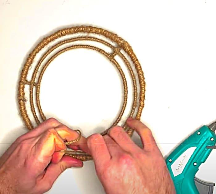 Wrap A Dollar Tree wreath Form With Jute To Make A Wood bead Chandelier