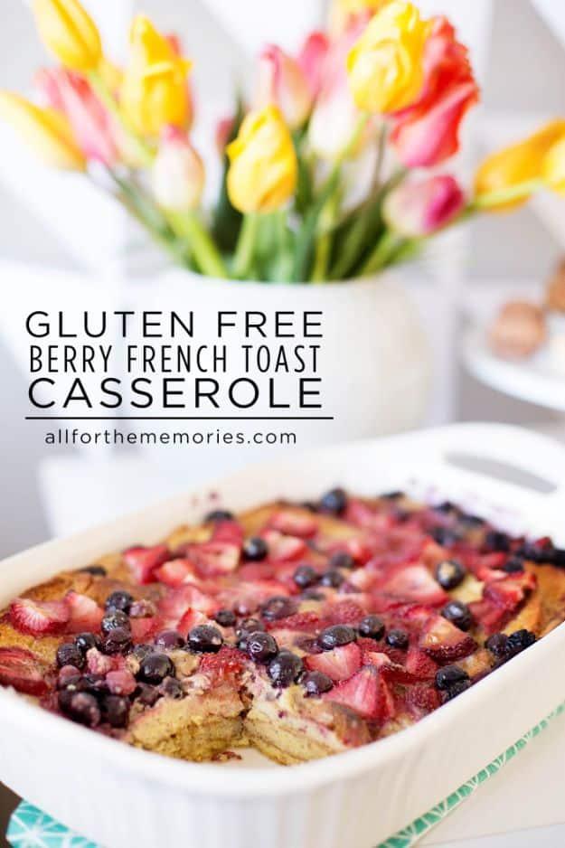 Gluten free berry French toast casserole in a baking dish with mixed berries baked into a maple custard