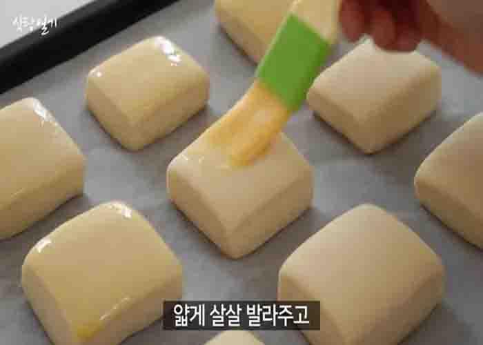 Brushing the top of the honey bread with some eggwash