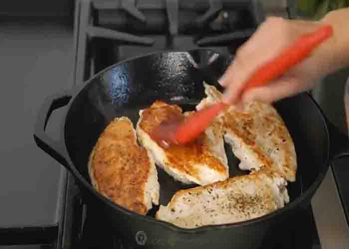 Brushing the Monterey chicken with BBQ sauce