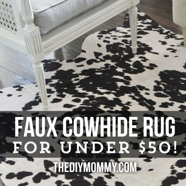Black and white faux cowhide DIY rug made from upholstery fabric on dark wood floor under a white cane settee