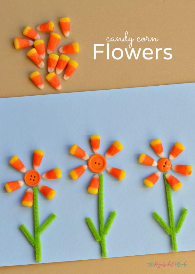 Pin graphic reading Candy Corn Flowers, three flowers with candy corn petals and orange button centers on blue paper