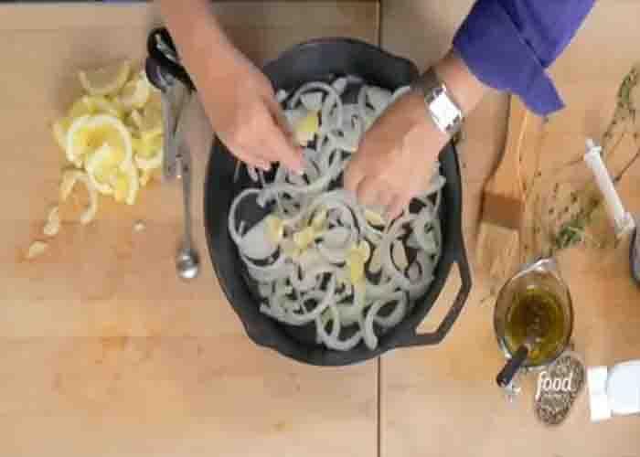 Arranging the roasted lemon chicken ingredients in the skillet
