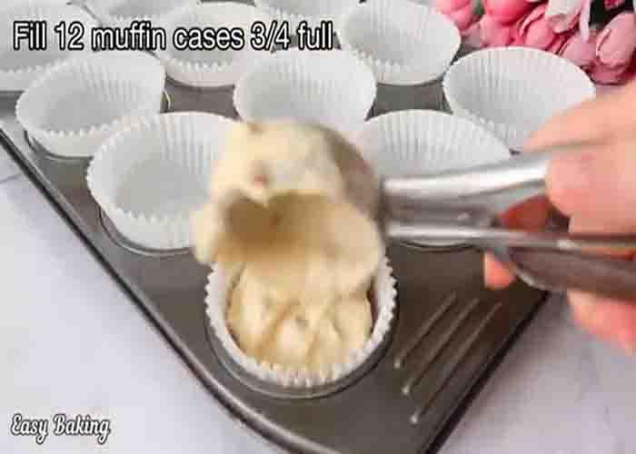 Dividing the almond muffin batter into the muffin cups