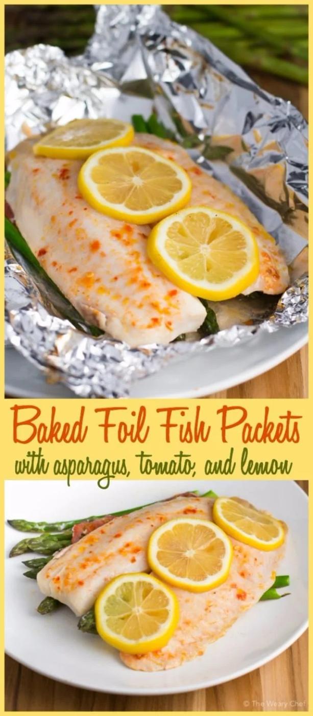 Baked fish foil packet paired with asparagus and tomato for a light healthy campfire dinner outdoors