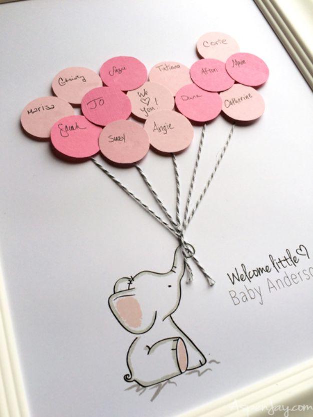 DIY baby shower decoration elephant guest book print with pink signed paper balloon circles on baker's twine in a frame