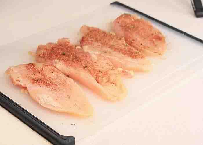 Seasoning the chicken breasts for the marry me chicken recipe