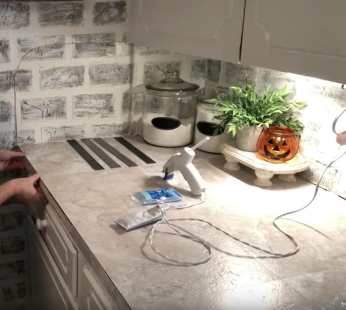 make a new counter surface with peel and stick tiles