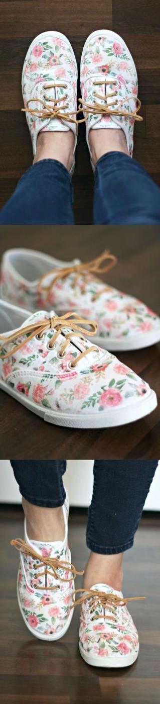 White canvas sneakers covered in pink and coral iron-on floral transfers, laced with tan leather laces