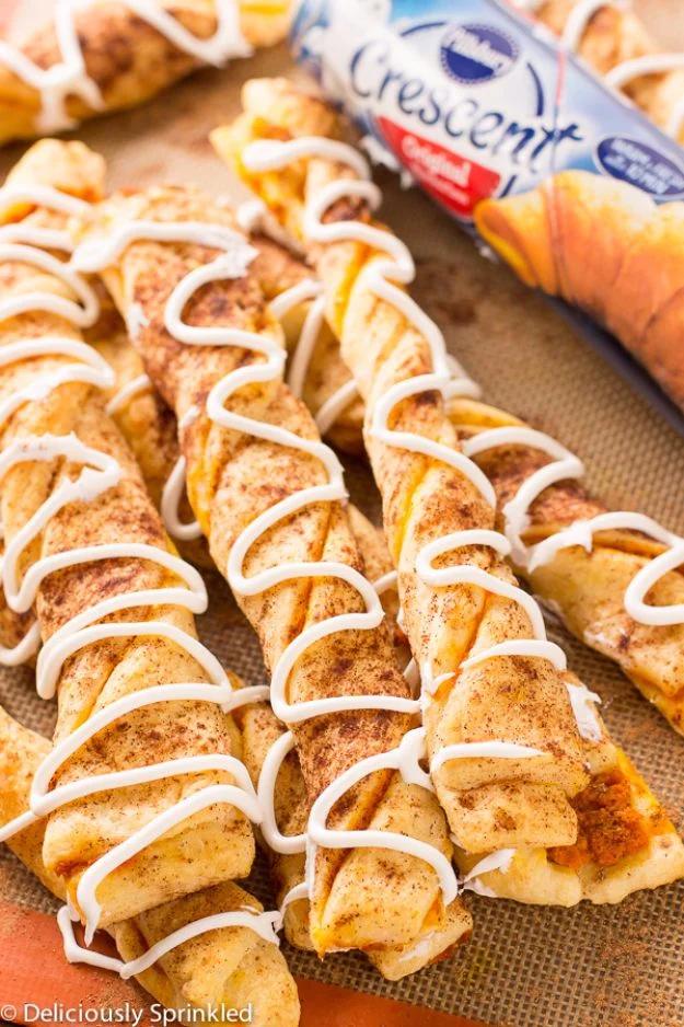 Pumpkin pie twists made from crescent dough with pumpkin filling, twisted and drizzled with cream cheese icing