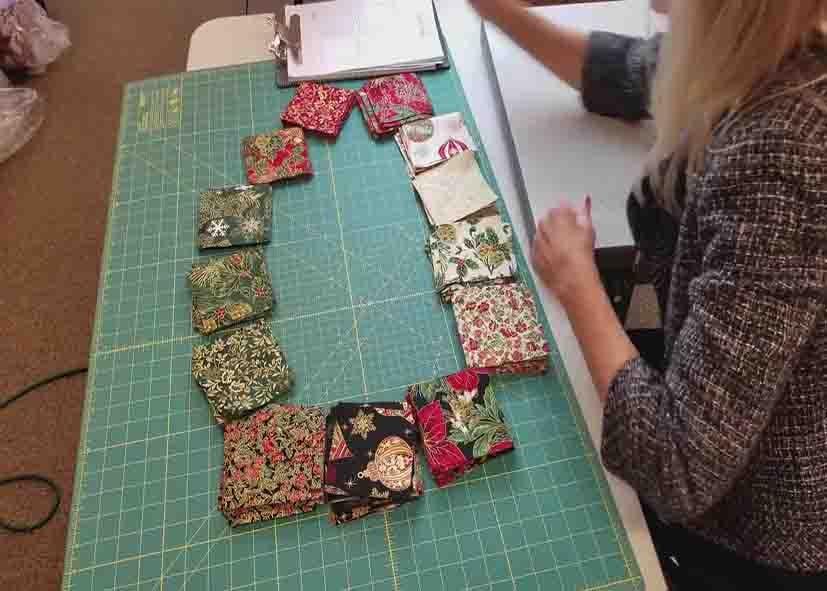 Stacking and laying down the fabric squares into a circular shape