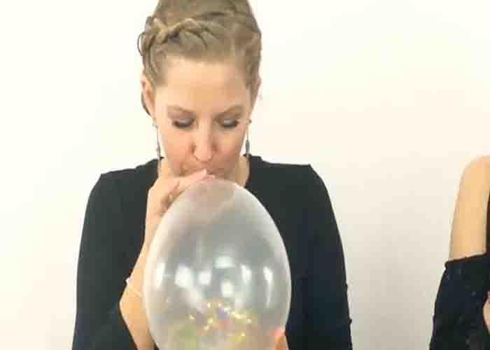 Blowing the balloon to make the new year confetti balloon