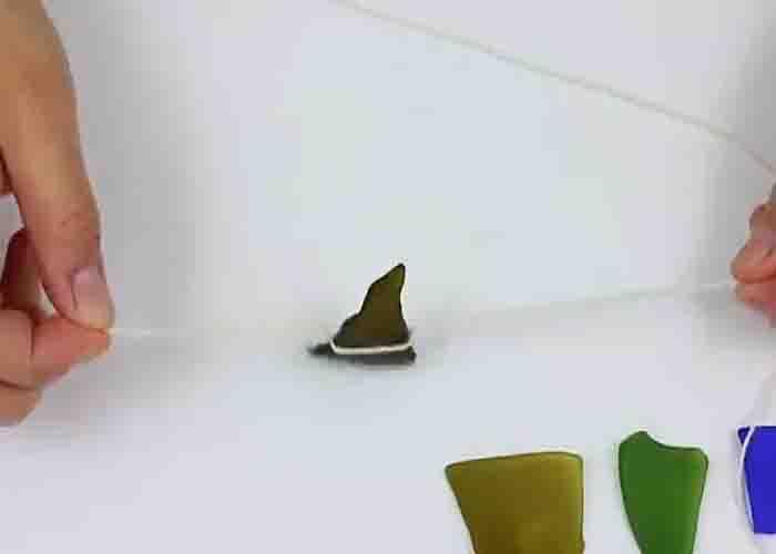Tying the faux sea glass to make the wind chime