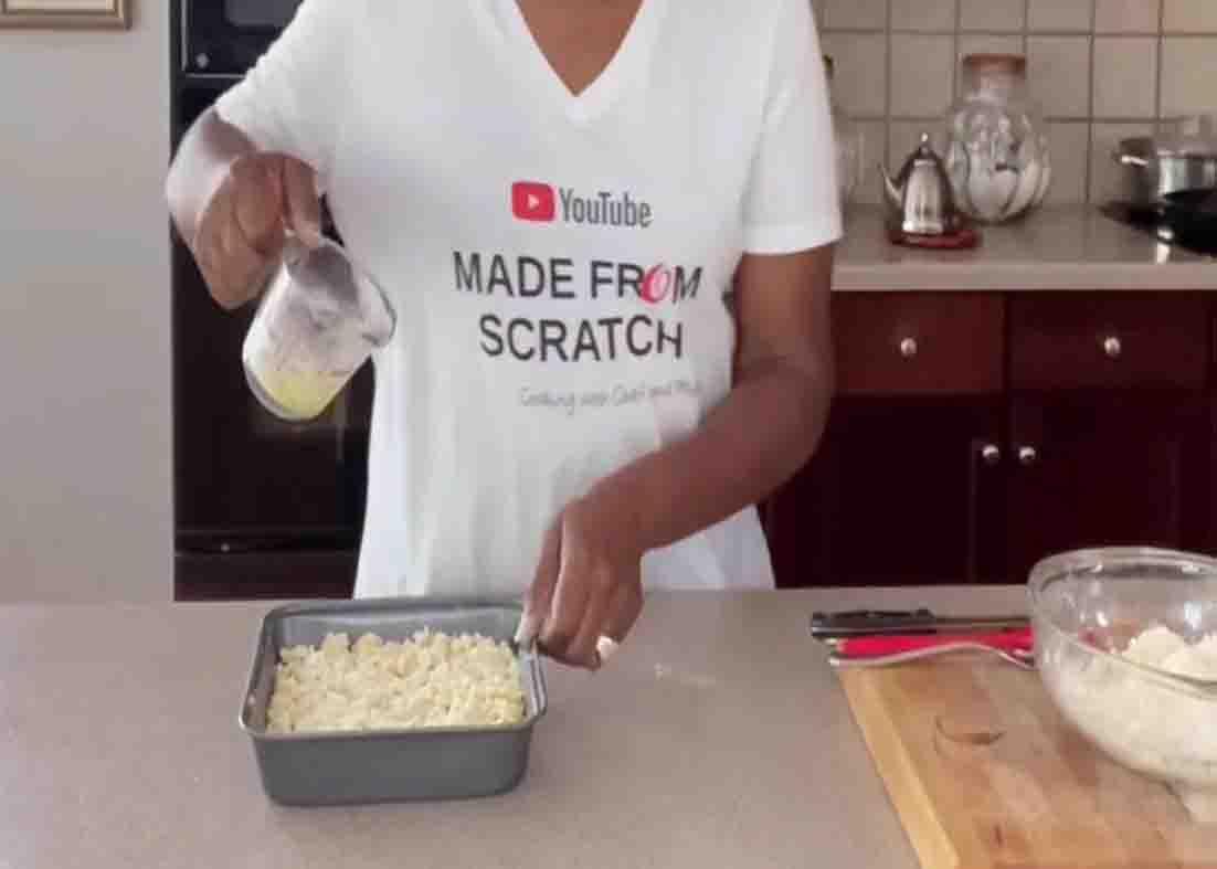 Finishing the pineapple blueberry dump cake with a drizzle of melted butter
