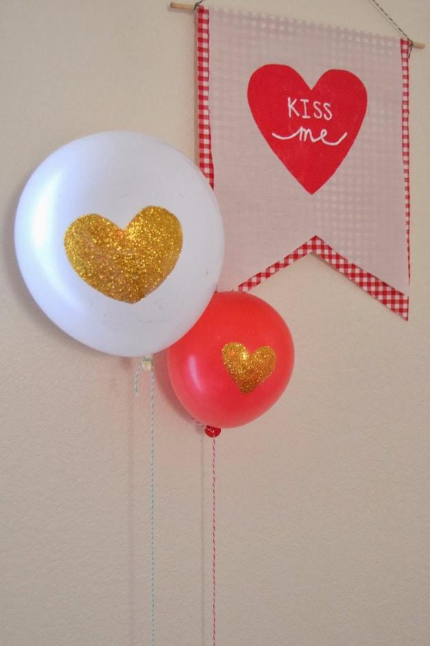 Large balloon decorated with a glitter heart on the front floating in a styled Valentine's Day photo
