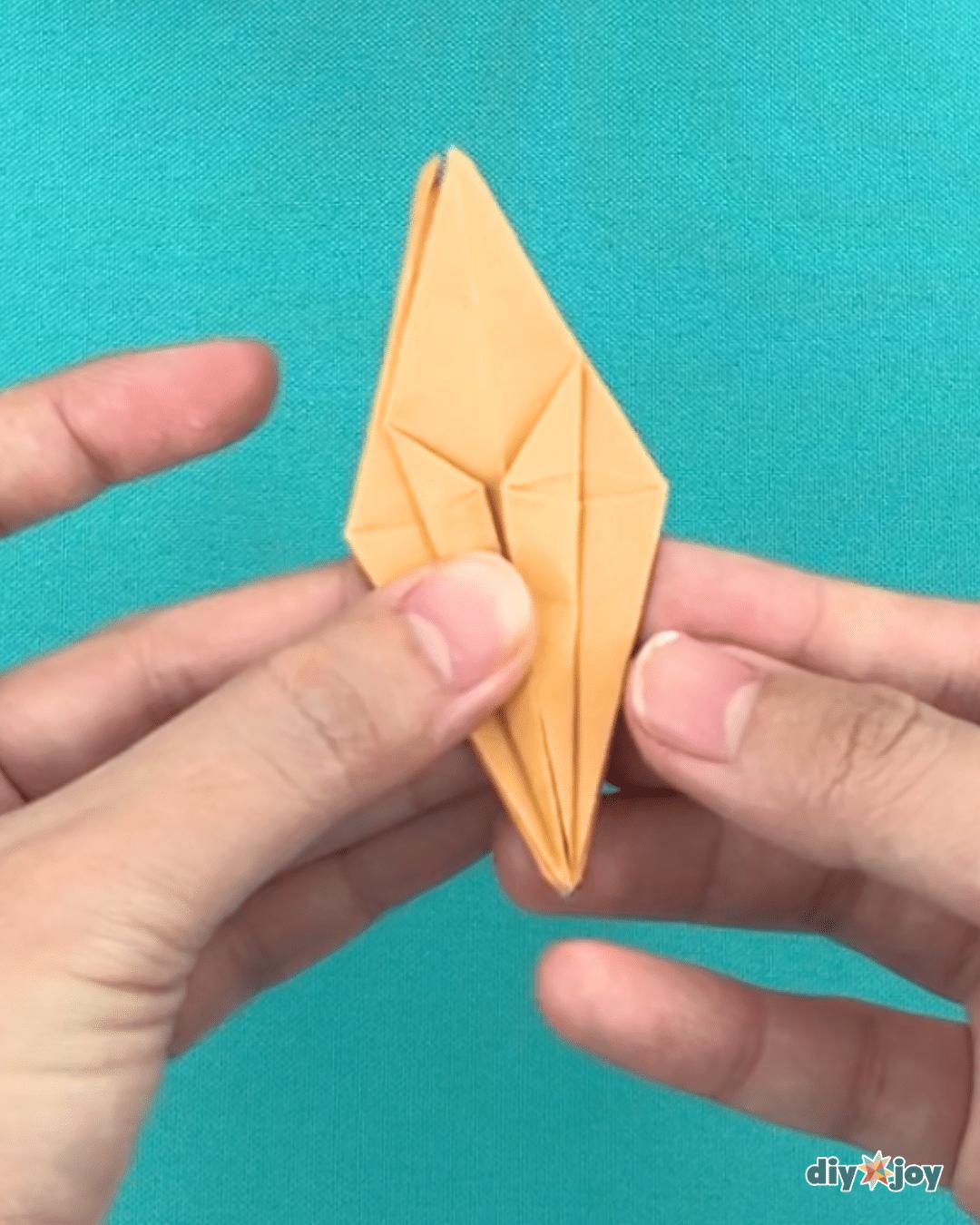 DIY paper lily flowers finished and standing upright, simple step by step instructions for folded paper blooms