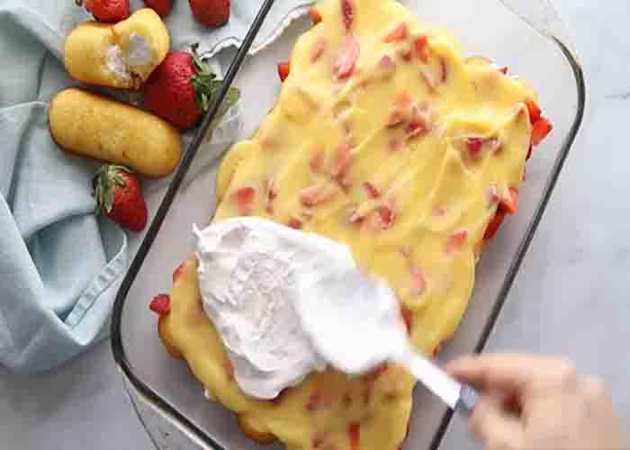 Assembling the strawberry twinkie cake