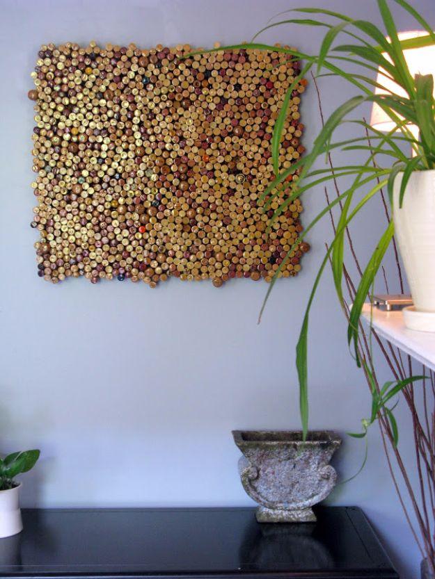 Square panel of hundreds of wine corks mounted on a wall beside a tall potted plant and a stone urn on a black table