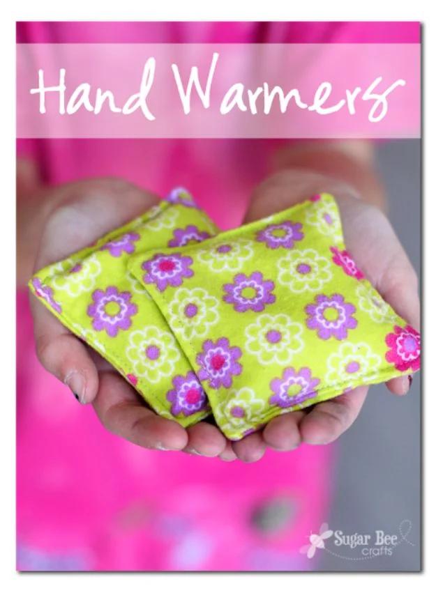 Hand warmers graphic, a child's cupped hands holding two green and purple floral fabric squares, name typeset above