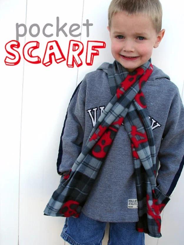 Sewing projects for boys pocket scarf in gray and red plaid fleece worn over a gray hoodie by a smiling young child