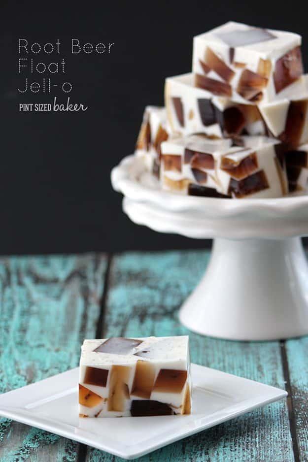 Root beer float jello cut into squares showing dark root beer cubes suspended in a pale vanilla layer