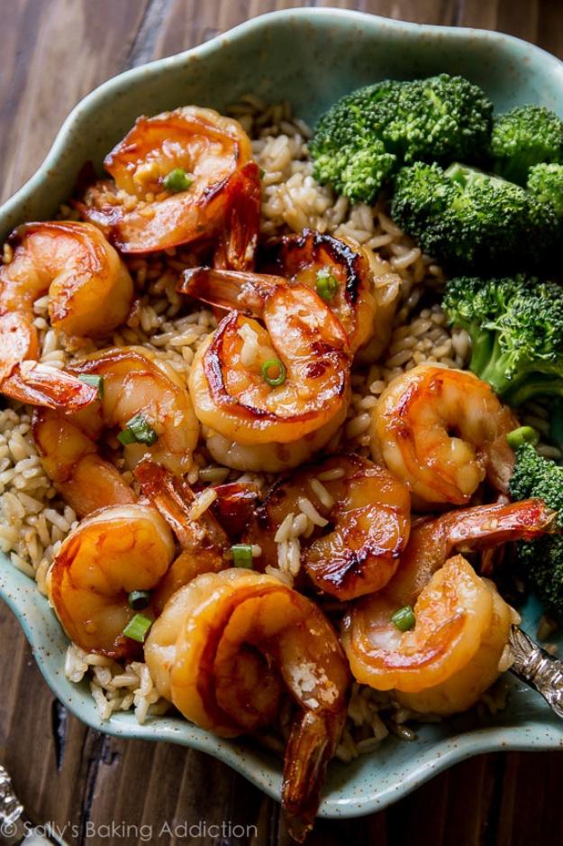 Honey garlic shrimp seared in a skillet with a caramelized glaze and scallions over brown rice for a twenty minute dinner