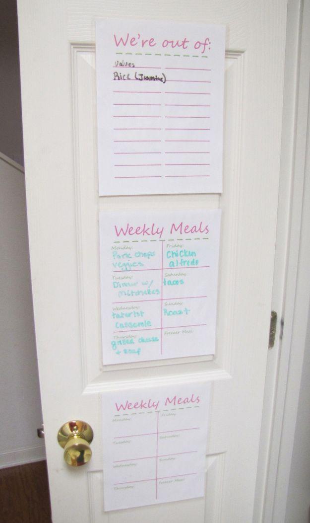 Pantry door with laminated printed sheets headed were out of and weekly meals, handwritten in colored marker