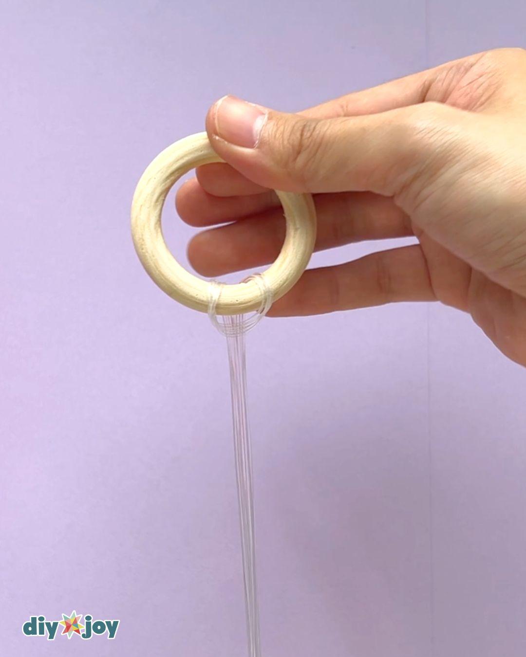 Easy bead crafts in progress, with eight and fourteen millimeter glass beads being threaded onto clear fishing line