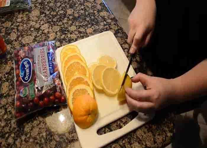 Slicing an orange and lemon for Christmas stovetop potpourri