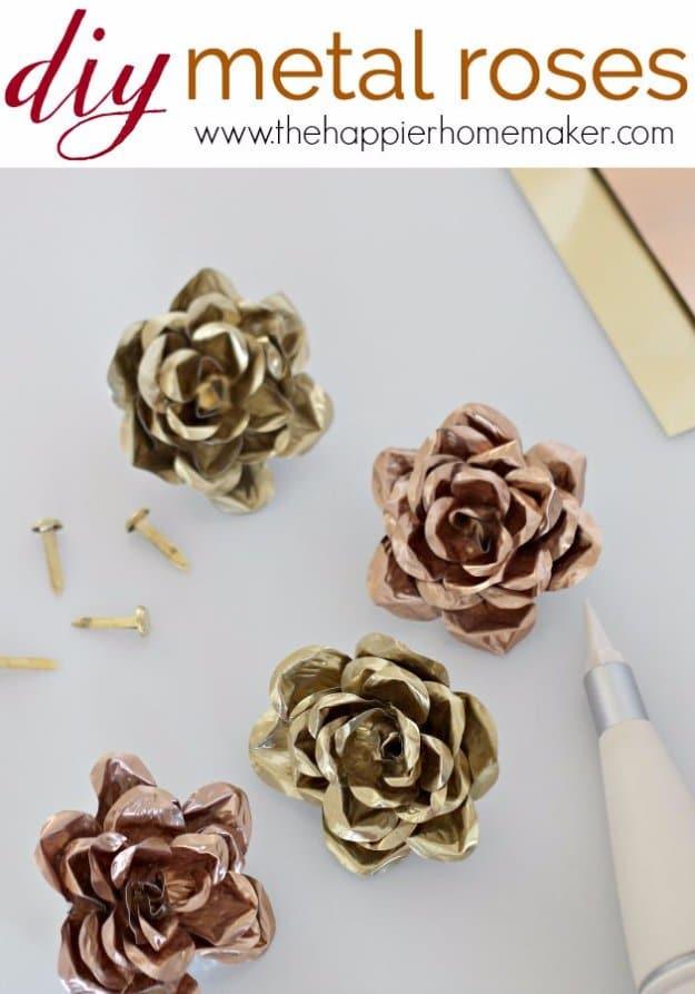 Rolled metal roses with wire stems finished matte black and antiqued gold, rustic crafts to sell in a small bunch