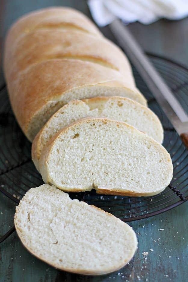 Classic Italian bread loaf with a chewy golden crust and a soft white interior on a parchment lined sheet