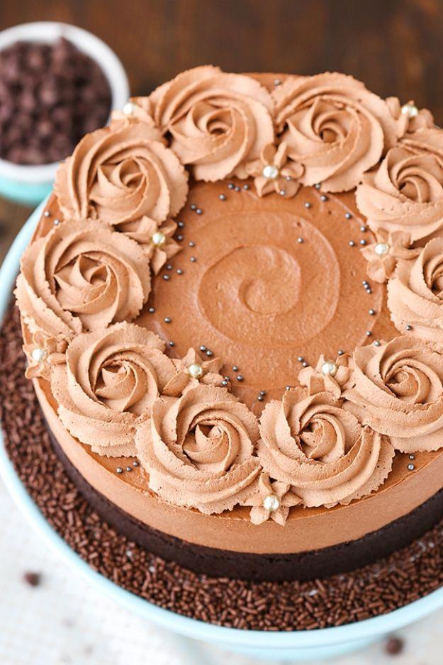 Guinness chocolate mousse cake finished with piped chocolate rosettes and sprinkles on a pale blue cake stand