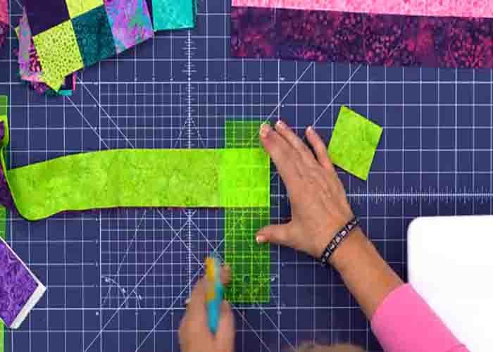 Cutting the strips to make the squares for the hopscotch quilt