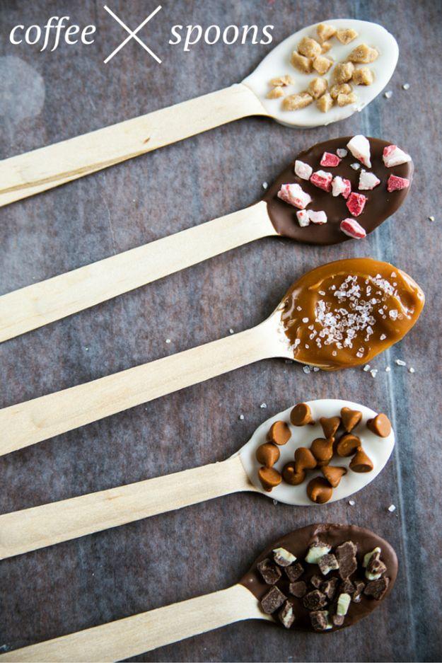 Five wooden coffee stirring spoons in a row coated in chocolate and caramel with peppermint, toffee and salt