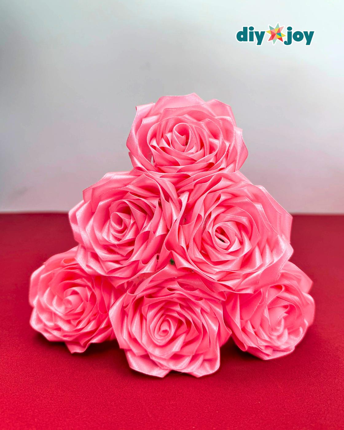 Handmade satin ribbon rose for Valentines Day, a red fabric flower made from folded and glued ribbon petals