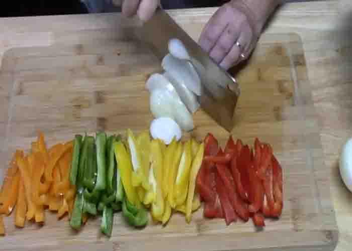 Chopping the bell pepper and onion for the crockpot chicken fajitas