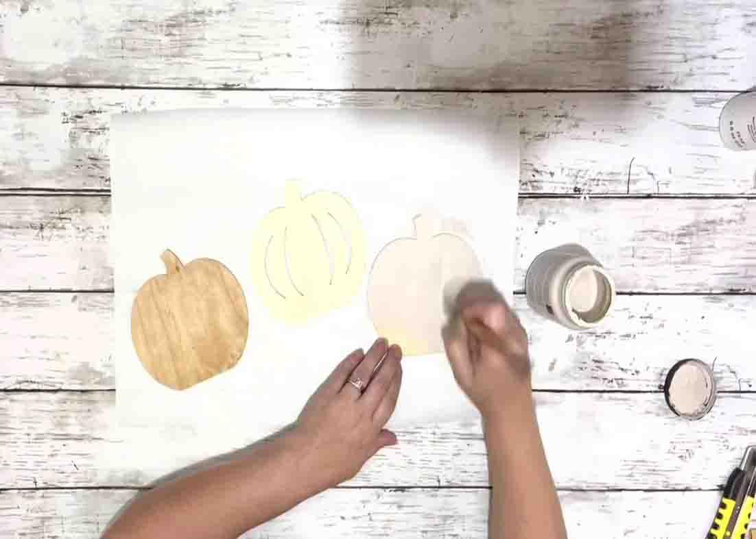 Painting the pumpkins for the fall decor