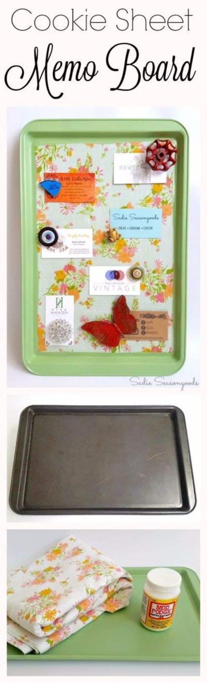 An old cookie sheet painted matte black and framed in wood hangs on a kitchen wall with notes held on by magnets