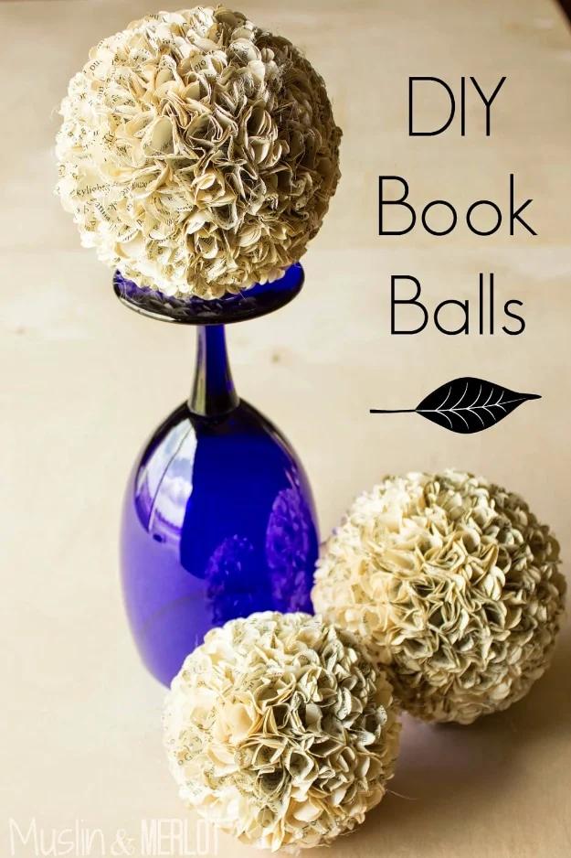 DIY book balls graphic, scalloped book page circles glued over foam balls, one balanced on a blue wine glass