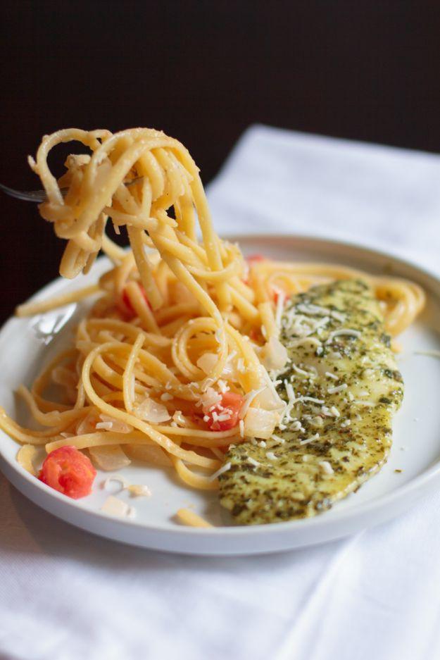 Pesto tilapia served over linguine with tomatoes and parmesan, an easy 30 minute fish and pasta dinner recipe