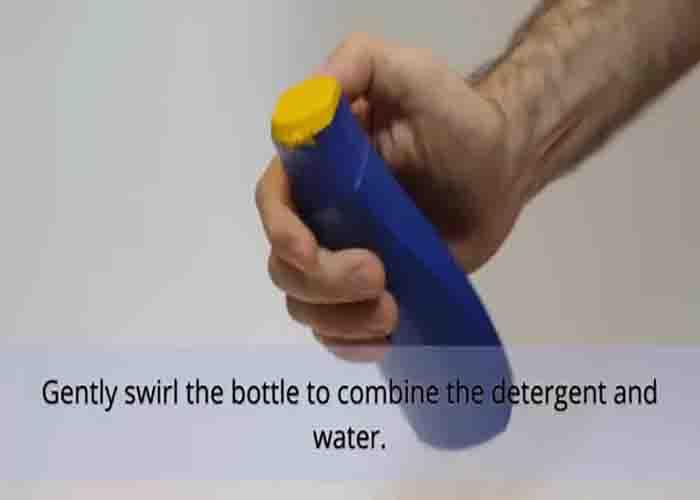 Spraying the detergent to the carpet