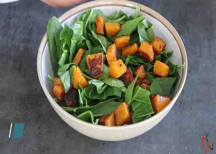 Assembling the roasted butternut squash spinach salad