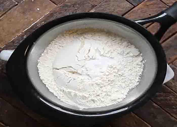 Sifting the flour for the butterfinger cookies recipe