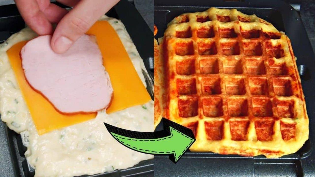 Loaded potato waffles cut in half showing melted cheddar and ham sealed inside a golden potato waffle