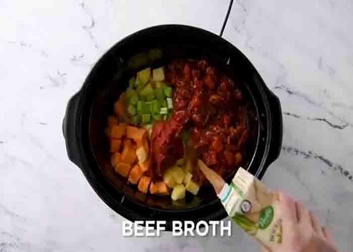 Adding the hamburger soup ingredients to the slow cooker