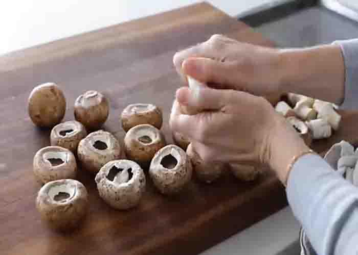 Removing the stem of the mushrooms