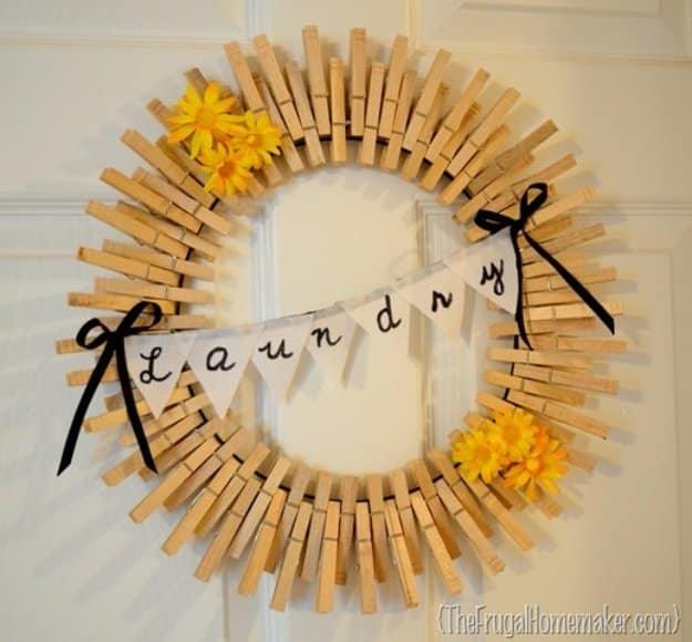 A sunburst wreath of clothespins clipped around a wire frame, painted in an ombre of teal, hung on a white door