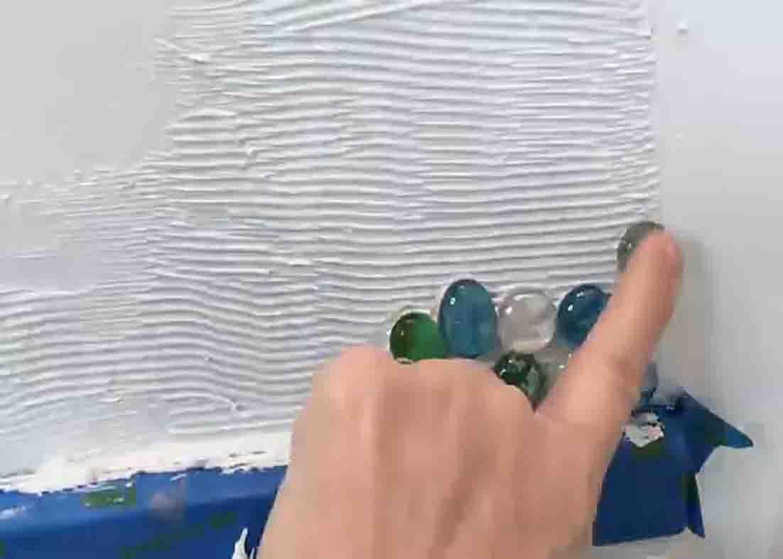 Attaching the gems as a backsplash in the bathroom