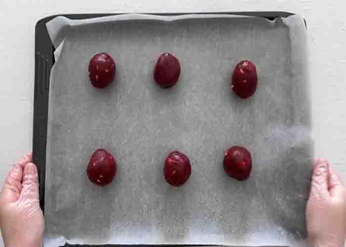 Shaping the red velvet cookies before baking